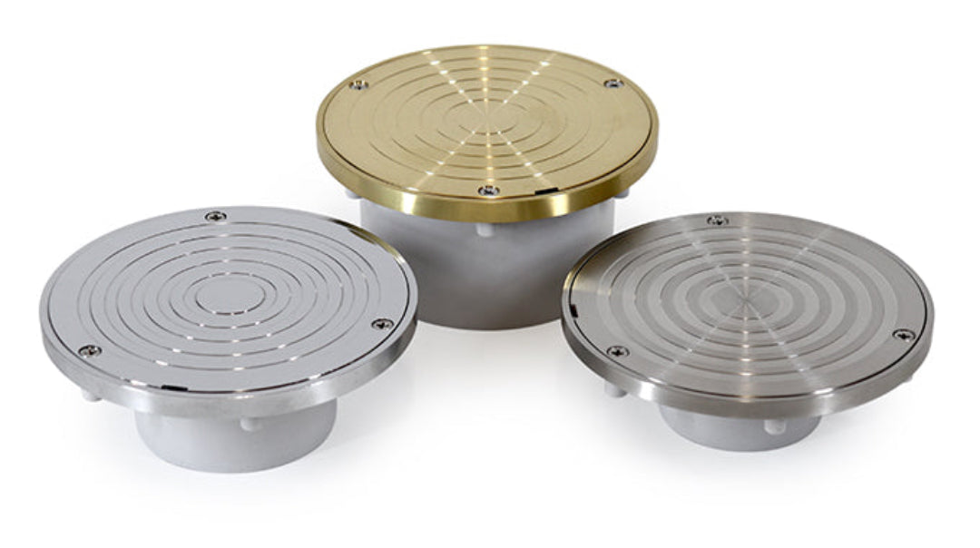 Three bolted trap covers in different metallic finishes (stainless steel, brass, chrome) for PVC DWV pipe.