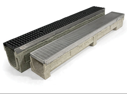 A channel drain with a metal grid on the top surface and a concrete base.
