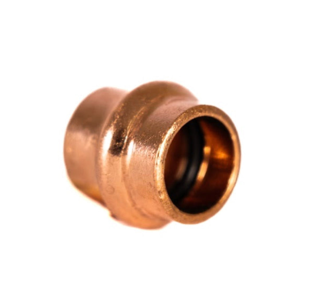 A copper press water end cap fitting, with a visible inner opening and characteristic 'V' shaped exterior.