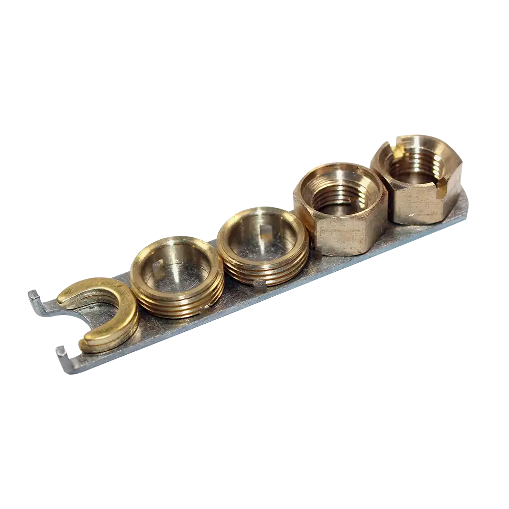 A set of gold-colored anti-vandal nuts and a spanner, likely made of chrome-plated metal, displayed on a grey background.