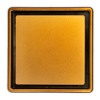 A copper shower drain grate designed for tiled floors.