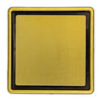 A gold shower drain grate designed for tiled floors.