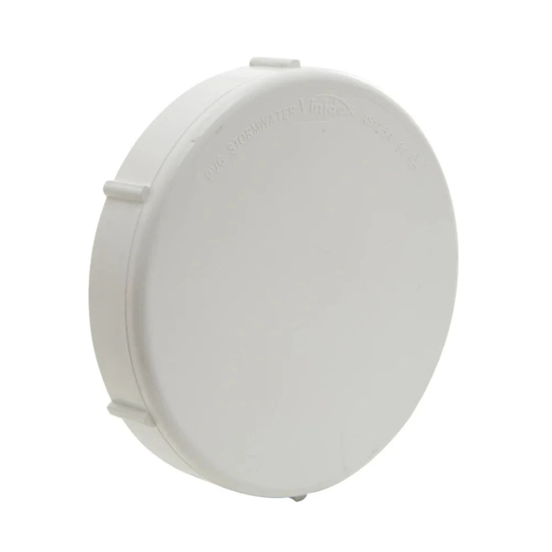 A white PVC threaded access cap for plumbing.
